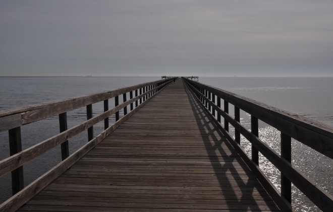 a pier jutting into Galveston Bay at Pine Gully Park, Seabrook